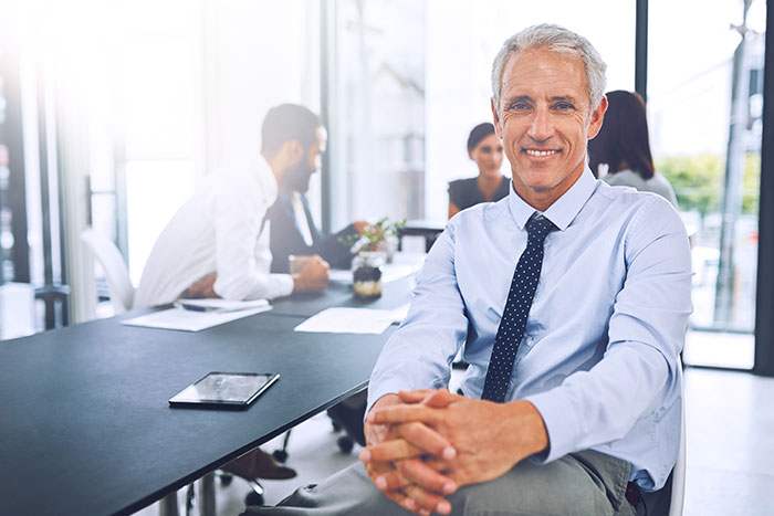 Mature businessman sitting in the office during a meeting