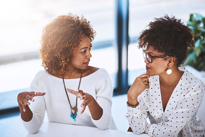 Two young women working in office