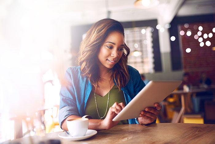 Young woman using a digital tablet in a cafe