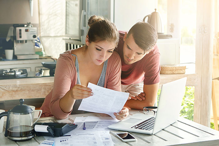 Young couple working on their budgets