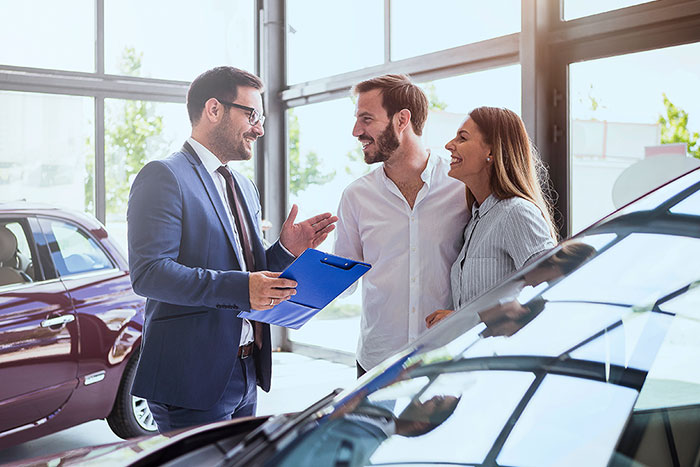 Young couple buying a car