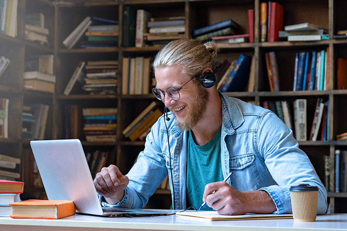 Happy young man study in library