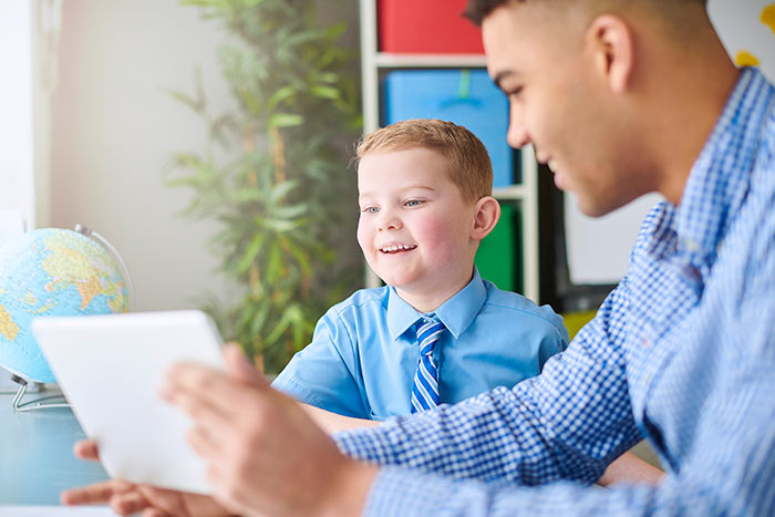 Schoolboy with trainee teacher