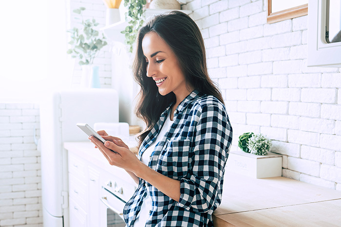 Young woman playing on her phone.
