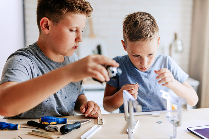 Kids playing with tools in the workshop