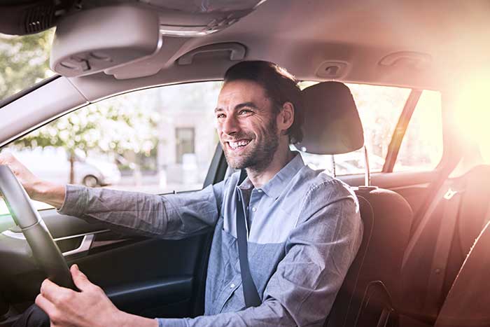 Confident businessman driving his car