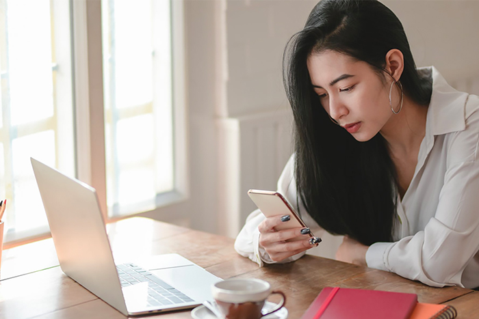 Asian lady looking at phone