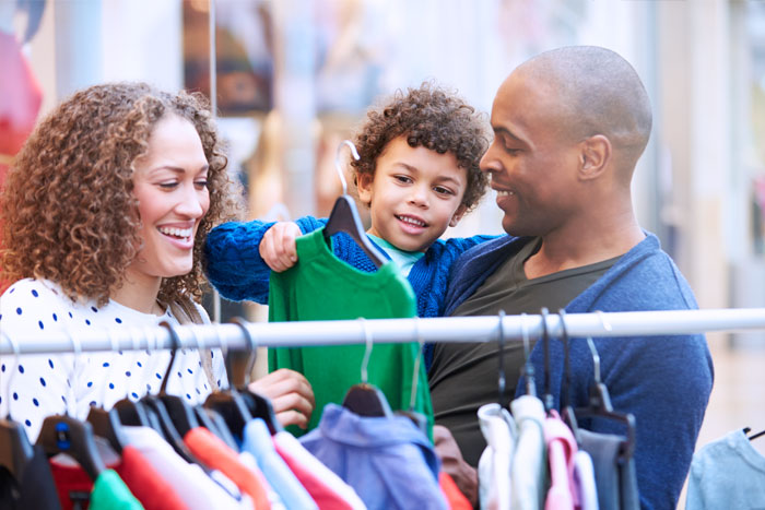 Mum & dad shopping for kids clothing.
