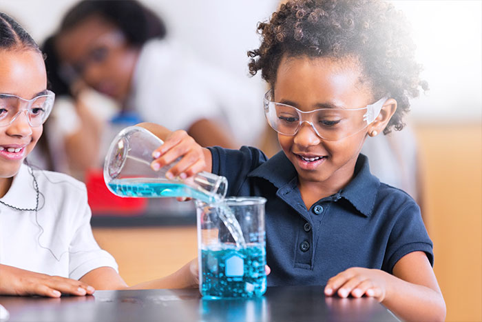 Young girl doing science experiment in class