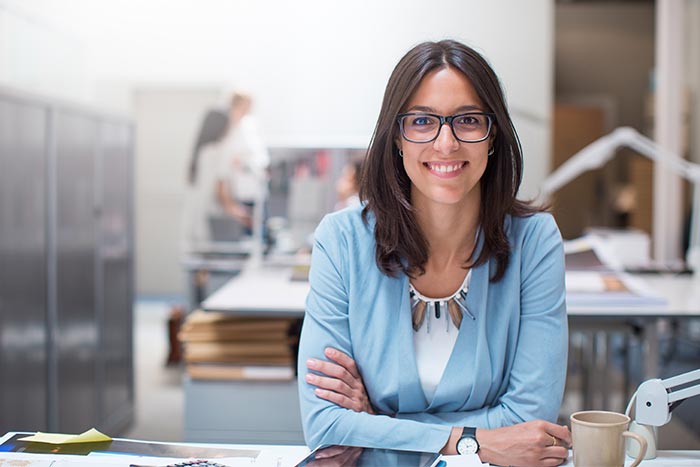 Business woman sitting at her desk in corporate office