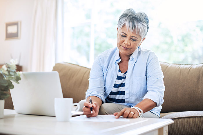 Senior woman doing paperwork at home