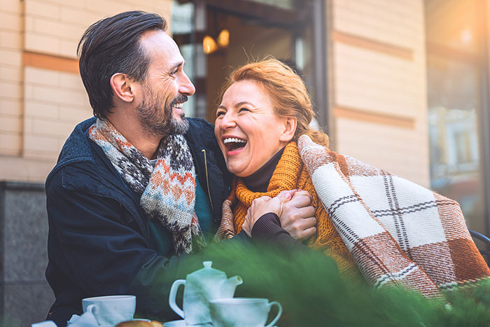 Man and woman enjoying outside at a cafe