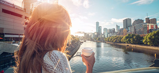 Young woman drinking coffee in sunny melbourne