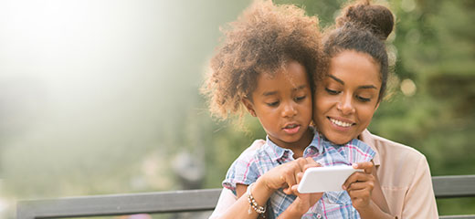 Mother and daughter using smartphone