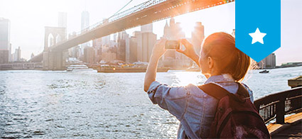 Young woman taking a photo of new york skyline