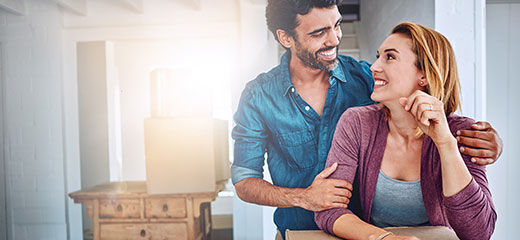Couple looking at each other smiling.